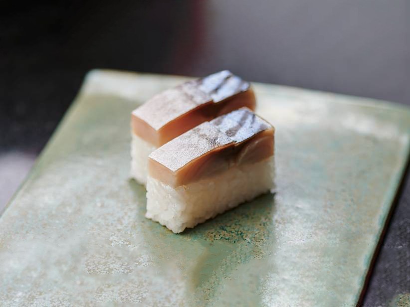 Pressed mackerel (saba) sushi placed on a glazed clay slab. Mackerel - Saba - 鯖