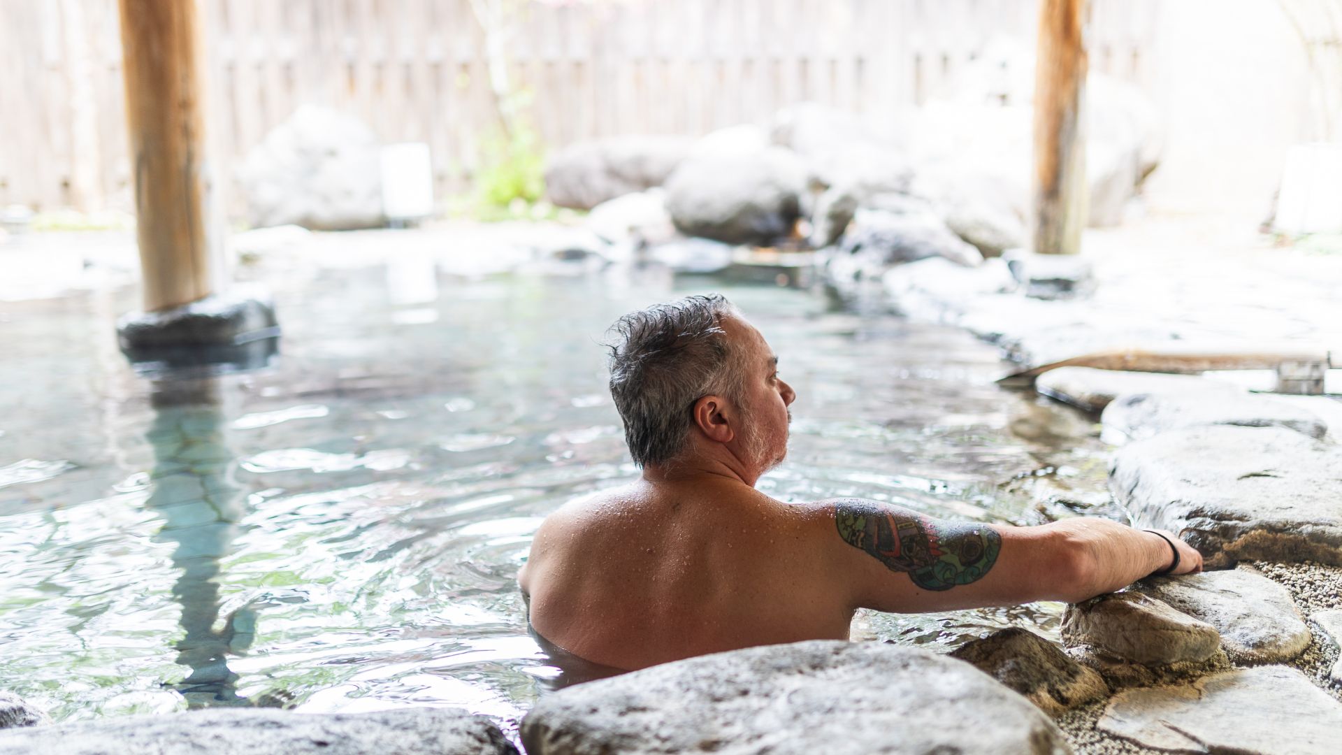 Hokkaido, man with tattoo in tattoo friendly hot spring (onsen)